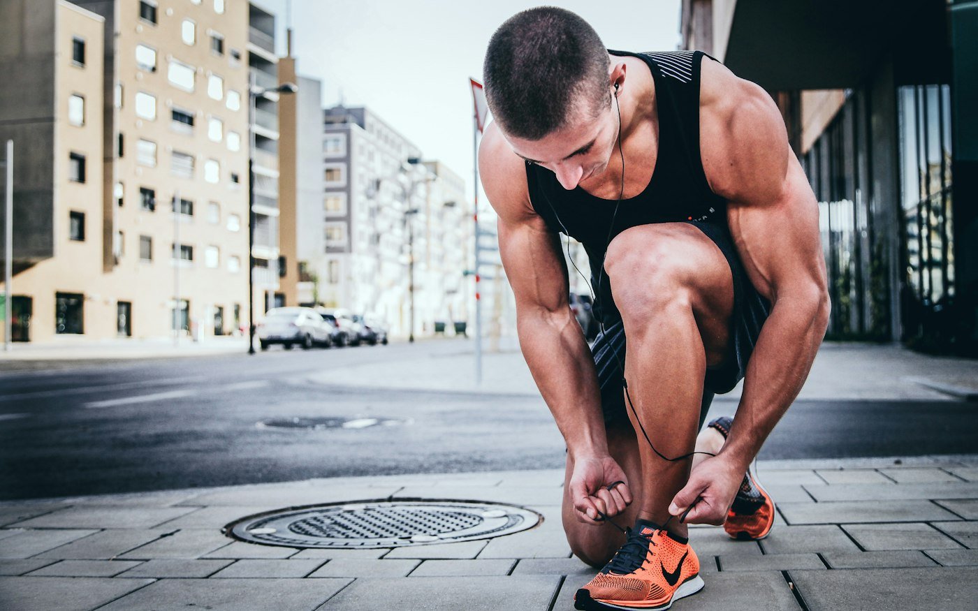 Runner tying his shoes before a run